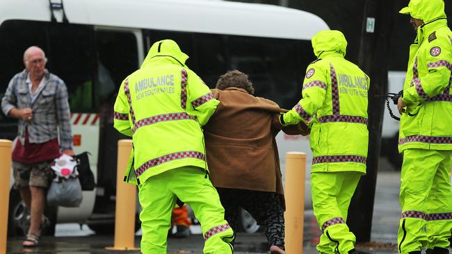 Ambulance personnel move evacuees from North Narrabeen / Picture: John Grainger