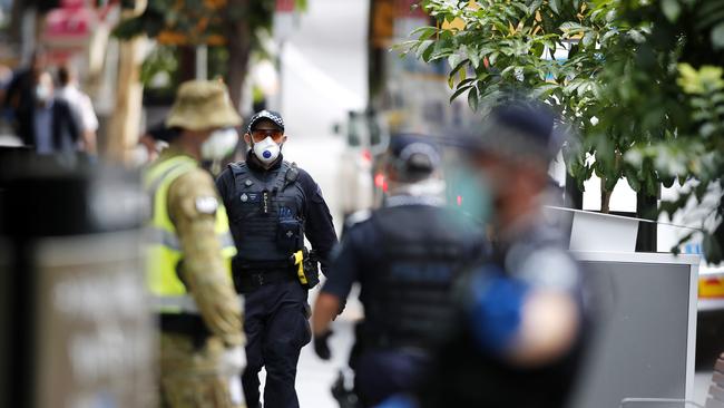 Australia Federal Police pictured at a Brisbane hotel escorting travellers into 14-day quarantine. Picture: AAP Image/Josh Woning