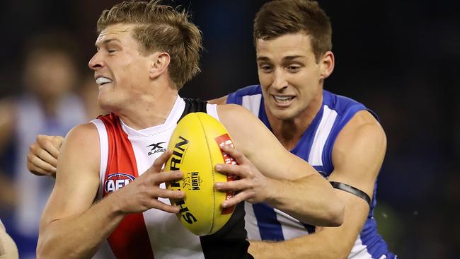 Jack Newnes charges past North Melbourne’s Shaun Atley. Picture: Michael Klein