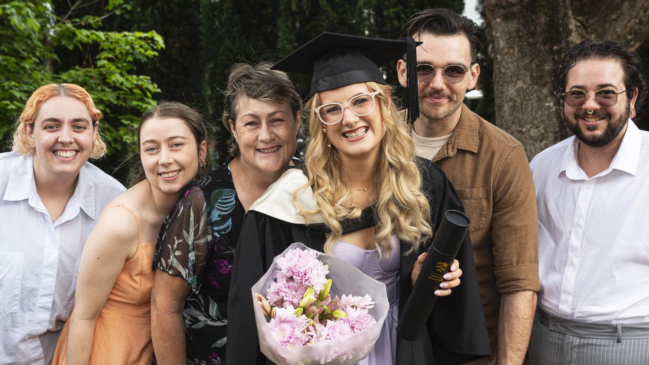 Double degree graduate Emily Kelleher (Bachelor of Arts and Bachelor of Laws) with family and friends (from left) Rhiannon Howard, Mandy Gabler, Donna Kelleher, Malcolm Kelly and Sigh Howard at a UniSQ graduation ceremony at The Empire, Wednesday, October 30, 2024. Picture: Kevin Farmer