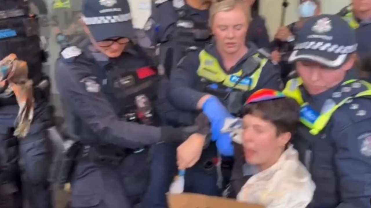 Police forcibly remove a protester.