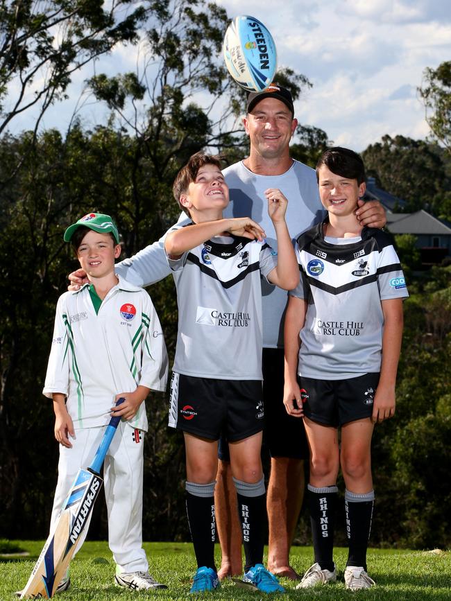 Nathan Hindmarsh and his kids (L-R) Rowdie (9) Buster (10) and Archie (12) pictured in their sports gear at their Glenhaven home, Sydney in 2018. Picture by Damian Shaw