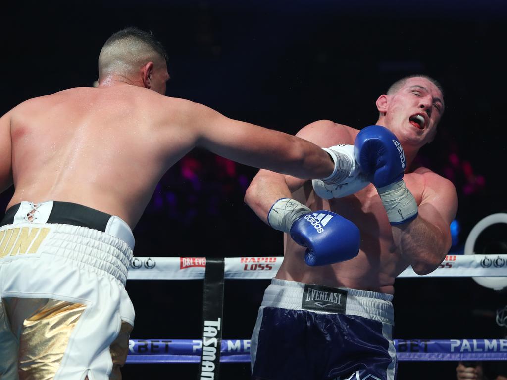 Gallen takes a blow from Justis Huni during their Australian heavyweight title bout. Picture: Richard Dobson