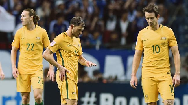 Dejected Socceroos after Japan’s first goal.