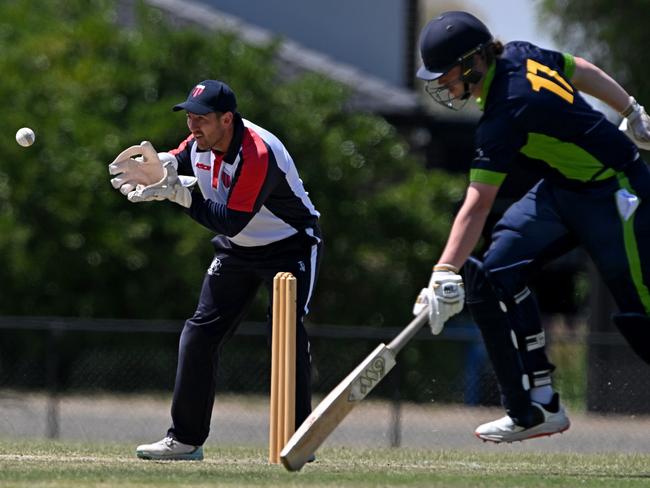 DDCA keeper Jordan Cleland takes the ball as VTCA batter Nathan Johnson makes his ground. Picture: Andy Brownbill