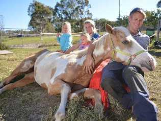 COMMUNITY HELP: Isabella and Sophie with the mum Gemma and Wayne Kerle, holding the slowly recovering Bella. Picture: Craig Warhurst