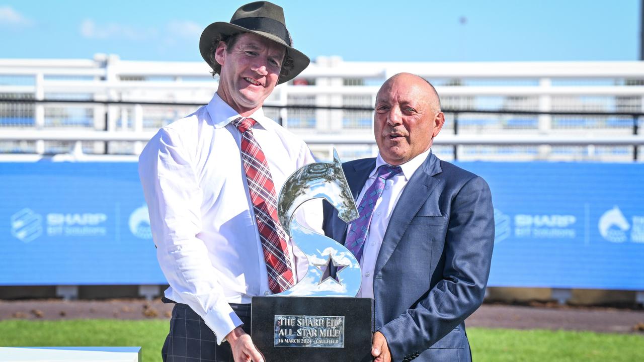 Trainer Ciaron Maher and owner Tony Ottobre hold the All-Star Mile trophy after Pride Of Jenni’s victory in the race in March. Picture: Reg Ryan / Racing Photos