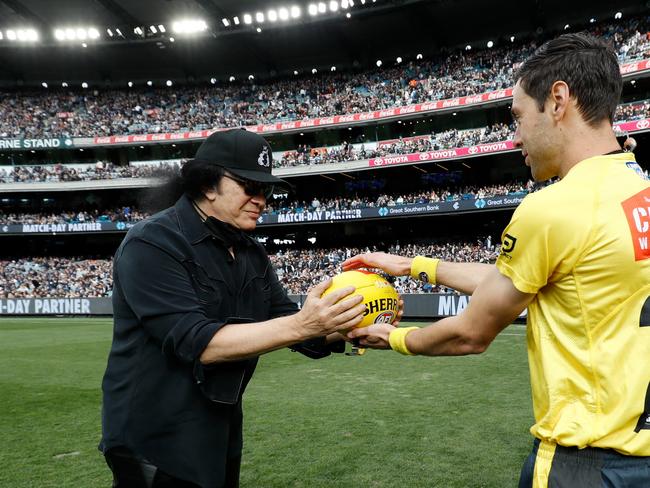 Carlton Blues fan Gene Simmons presents the match-day ball for the clash against the Collingwood Magpies at the MCG. Picture: Dylan Burns/AFL Photos via Getty Images