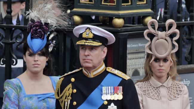 Prince Andrew, centre, and his daughters Princess Eugenie, left, and Princess Beatrice leave Westminster Abbey at the wedding of Prince William and Catherine.