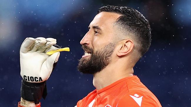 Paul Izzo of Victory holds a hot chip after they were thrown at him during the round one A-League Men's match. Picture: Cameron Spencer / Getty Images