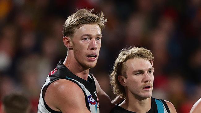 ADELAIDE, AUSTRALIA - MAY 02: Jason Horne-Francis of the Power with team mates Todd Marshall, and Miles Bergman after kicking a goal during the 2024 AFL Round 08 match between the Adelaide Crows and the Port Adelaide Power at Adelaide Oval on May 02, 2024 in Adelaide, Australia. (Photo by Sarah Reed/AFL Photos via Getty Images)