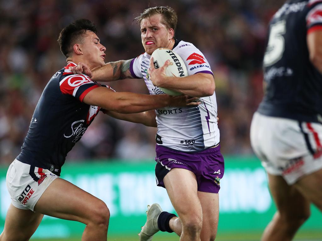 Melbourne's Cameron Munster tackled by Roosters Joseph Manu during the 2018 NRL Grand Final between the Sydney Roosters and Melbourne Storm at ANZ Stadium. Picture. Phil Hillyard