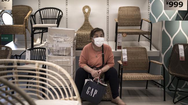 A customer wears a protective mask while sitting on a chair in an IKEA store in Wuhan, China. Picture: Getty Images