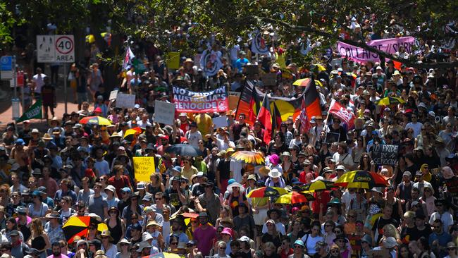 Protesters march down Pitt Street during an Invasion Day rally in Sydney. Photo: AAP