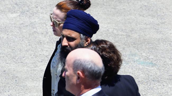 Queensland Police officers and detectives escort Rajwinder Singh from a chartered jet to a waiting police car at Cairns Airport. Picture: Brendan Radke