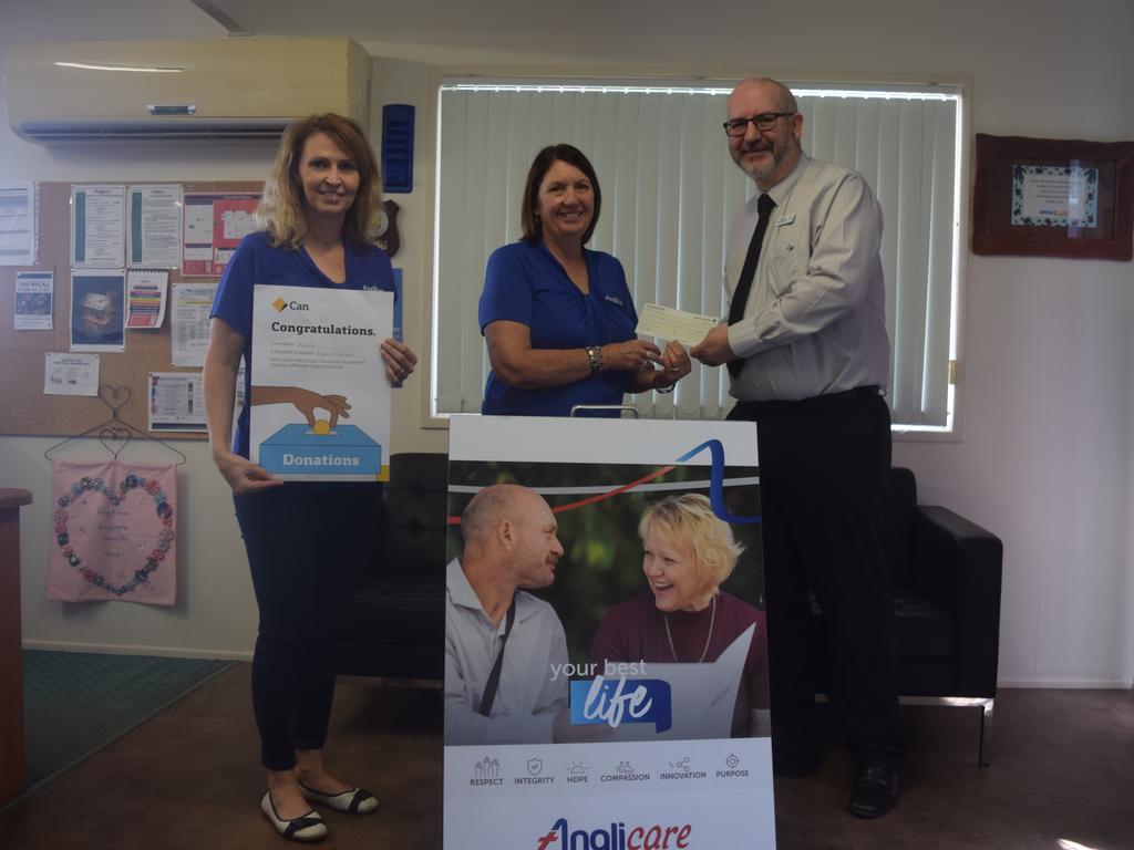 GIVING SEASON:Commonwealth Bank Biloela Manager Jason Spence handing over the donation to Anglicare CQ's Deborah Vonhoff and Lori Simpkins.