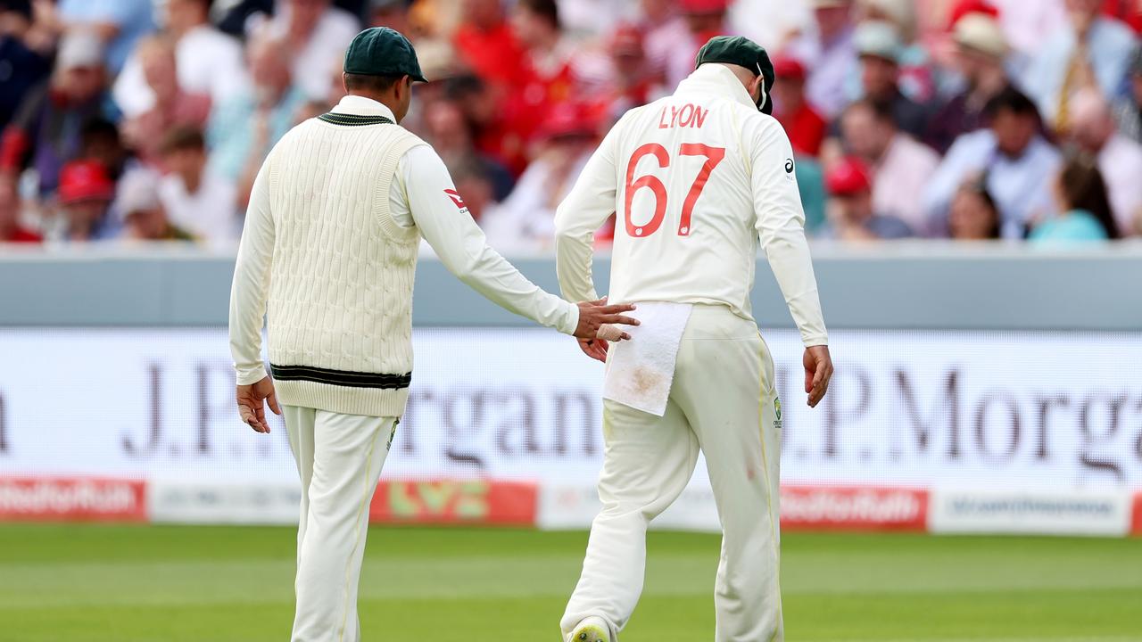 Nathan Lyon leaves the ground after injuring his calf in a fielding mishap. Picture: Ryan Pierse/Getty Images