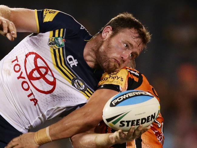 SYDNEY, AUSTRALIA - MAY 23: Gavin Cooper of the Cowboys offloads the ball in a tackle during the round 11 NRL match between the Wests Tigers and the North Queensland Cowboys at Campbelltown Sports Stadium on May 23, 2015 in Sydney, Australia. (Photo by Matt King/Getty Images)