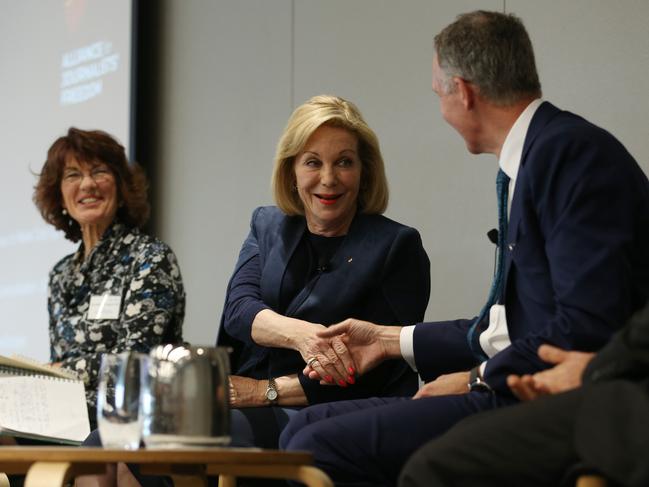 Brought together by the AFP raids. ABC Chair Ita Buttrose shakes hands with News Corp’s Campbell Reid as moderator Geraldine Doogue looks on. Picture: Britta Campion/The Australian