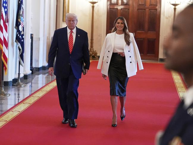 President Donald Trump, left, and first lady Melania Trump arrive at an event for Military Mothers in the East Room of the White House in Washington. Picture: AP