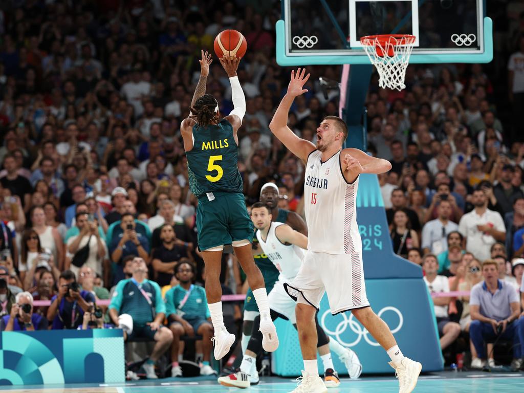 Patty Mills hits the game-typing shot over Nikola Jokic. (Photo by Jamie Squire/Getty Images)