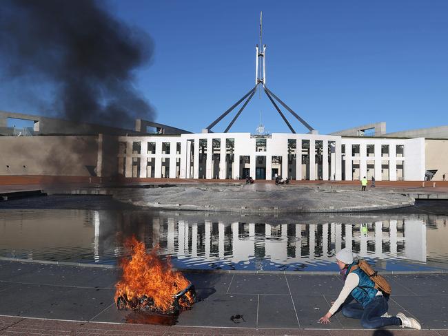 CANBERRA, AUSTRALIA - NewsWire Photos, AUGUST 09 2021: Extinction Rebellion protesters have attacked the front of Parliament House, lighting a baby's pram in Canberra. Picture: NCA NewsWire / Gary Ramage