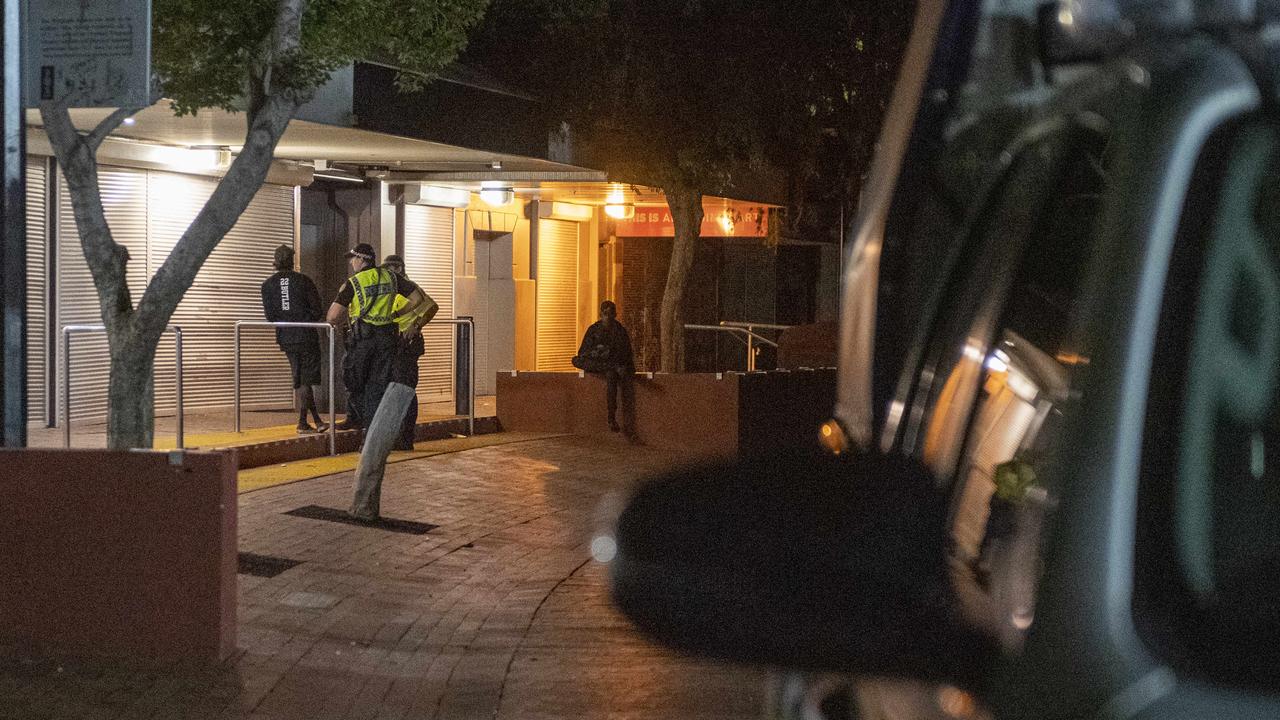 Police officers chat to a young man in Alice Springs. Picture: Mark Brake