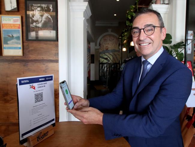 South Australian Premier Steven Marshall checks in using a QR code at the Stag hotel, in the city’s east end. Picture: Kelly Barnes/Getty Images