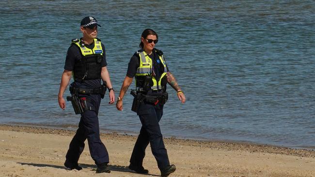 Police officers patrol St Kilda Beach. Picture: AAP