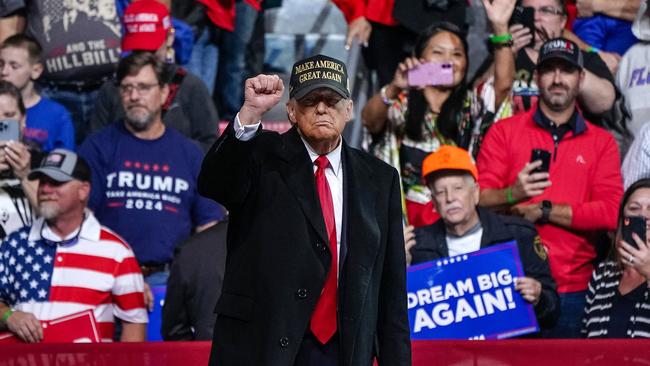 Former US President and Republican presidential candidate Donald Trump pumps his fist after speaking at the end of a campaign rally at Atrium Health Amphitheater in Macon, Georgia, on November 3, 2024. (Photo by Elijah Nouvelage / AFP)