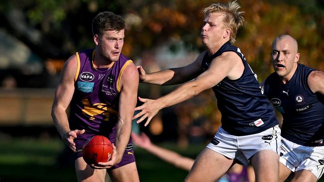 VAFA: Collegians’ Sam Hibbins tries to escape Charles Dowling of Old Melburnians. Picture: Andy Brownbill