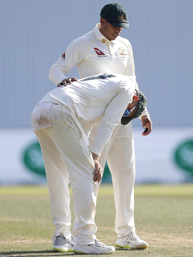 A shattered Nathan Lyon (front) and Usman Khawaja come to terms with defeat. Picture: Getty Images