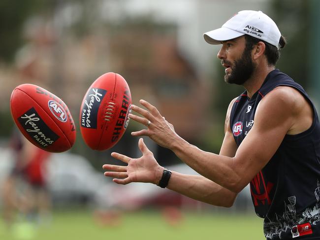 MELBOURNE, AUSTRALIA - DECEMBER 14: Jordan Lewis of the Demons handballs during a Melbourne Demons AFL training session at Gosch's Paddock on December 14, 2016 in Melbourne, Australia. (Photo by Robert Cianflone/Getty Images)