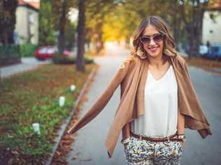 A young fashionable girl walking through the city and posing. Picture: freemixer