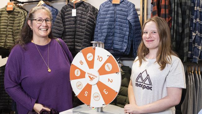 Spinning to win an opening day prize after making a purchase is Tamara Counter with Macpac staff member Zoey Twidle as the shop opens in Grand Central, Saturday, May 25, 2024. Picture: Kevin Farmer