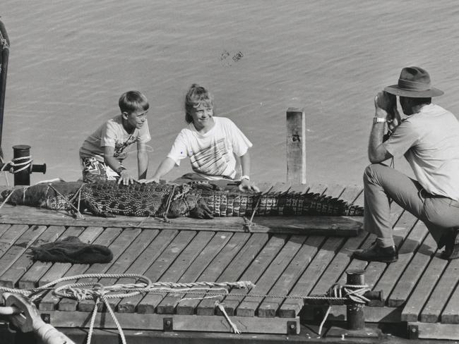 Lieutenant-Colonel Mansfield snaps a shot of Charles, 9, and Zoe, 11, and the Conservation Commission’s latest reptilian acquisition from Woods Inlet in Darwin Harbor.