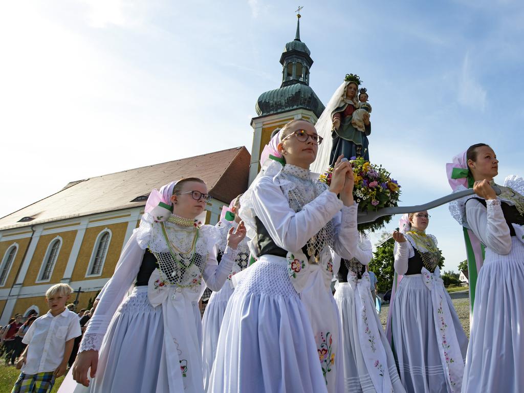 Women dressed in traditional clothes carry the statue of Virgin Mary during a procession in front of the Roman Catholic pilgrimage church in Rosenthal, eastern Germany. Picture: AP