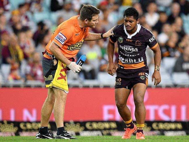 Anthony Milford of the Broncos receives attention from a trainer after a late shoulder charge from George Burgess.