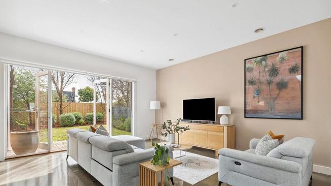 The living space overlooks the landscaped yard.