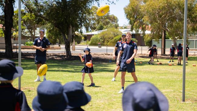 Adelaide Crows players Darcy Fogarty and Mitch Hinge with primary school students enjoying the Adelaide Crows Superclinic at Berri Primary School, February 7, 2023. Picture: Morgan Sette