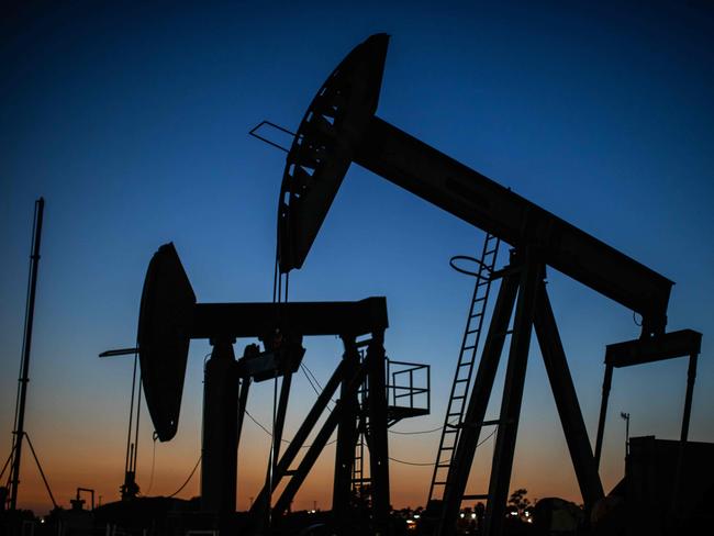 TOPSHOT - Oil pumpjacks operate at dusk Willow Springs Park in Long Beach, California on April 21, 2020, a day after oil prices dropped to below zero as the oil industry suffers steep falls in benchmark crudes due to the ongoing global coronavirus pandemic. - President Donald Trump on April 21 ordered his administration to come up with a plan to aid US oil companies struggling with a massive supply glut and record-low crude prices. 
