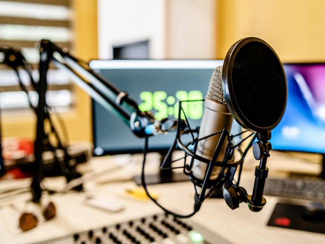 Microphone and mixer at the radio station studio broadcasting news. iStock