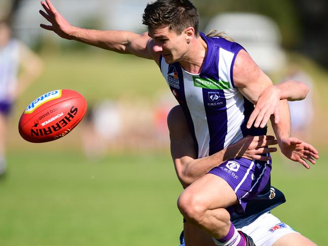 Benjamin Homburg of Edwardstown tackles Jake Johansen of CBC during the Adelaide Footy League division four grand final - CBC Old Collegians v Edwardstown at St Marys Park Saturday September 14,2019.(Image AAP/Mark Brake)