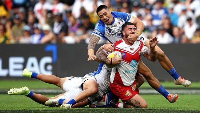 Andrew Fifita of Tonga is tackled by the Samoa defence in a men's pool game during the Downer Rugby League World Cup 9s in Sydney on October 19 last year. Picture: Brendon Thorne/AAP