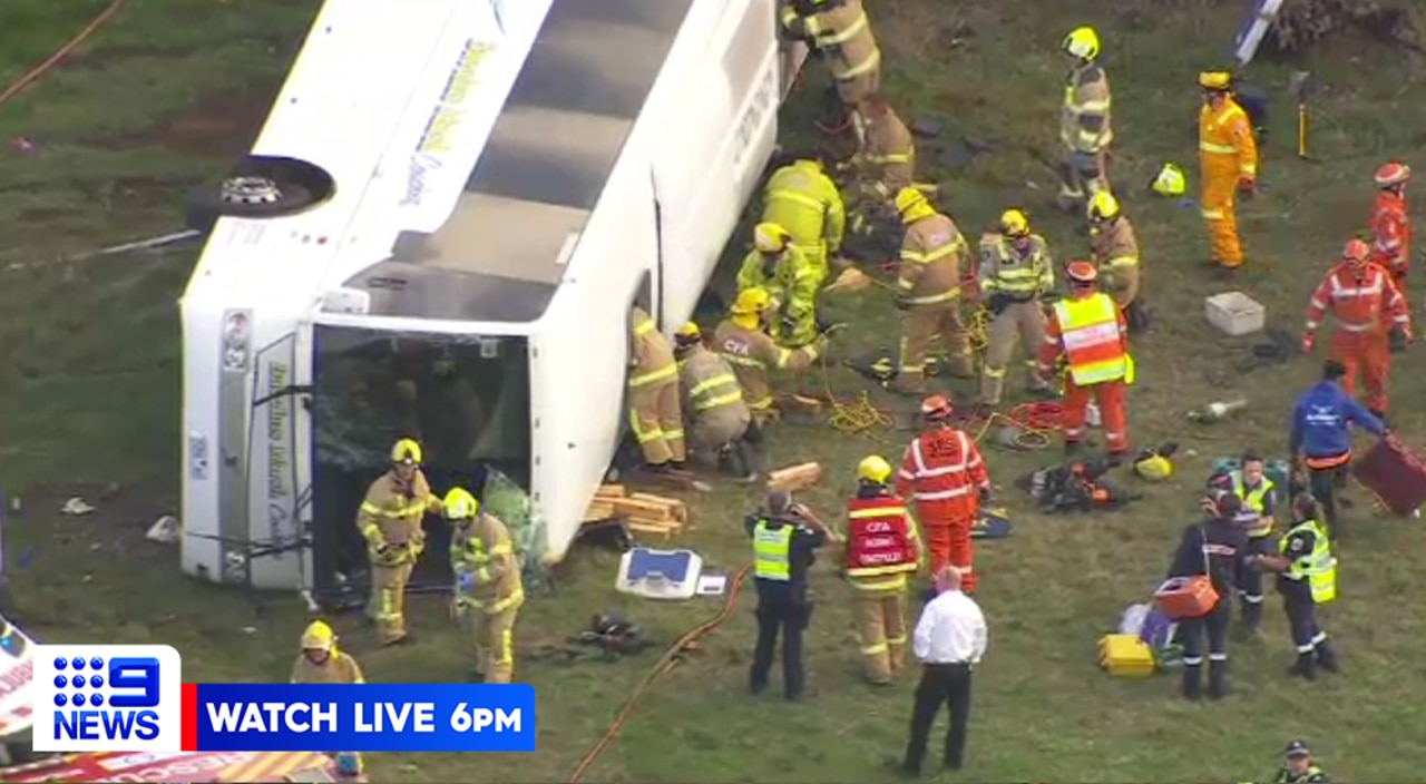 Emergency crews working to rescue children from the bus. Picture: Nine News