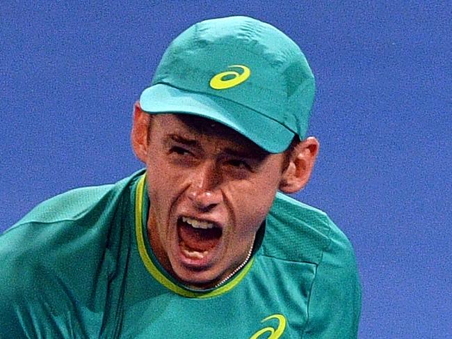 Alex De Minaur of Australia celebrates his victory against Milos Raonic of Canada in their men's singles second round match at Pat Rafter Arena during the Brisbane International tennis tournament in Brisbane on January 3, 2018. / AFP PHOTO / SAEED KHAN / IMAGE RESTRICTED TO EDITORIAL USE - STRICTLY NO COMMERCIAL USE