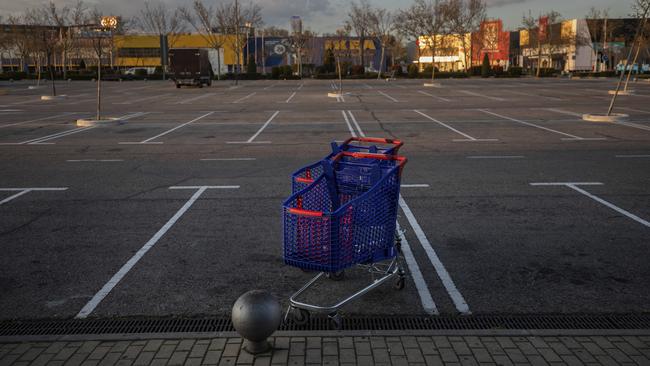 Shopping carts in the middle of an empty parking lot in at shopping area in the outskirts of Madrid. Picture: AP