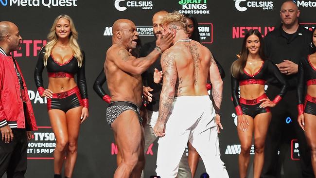 Mike Tyson slaps Jake Paul as they face off during their ceremonial weigh-in. Photo: Christian Petersen/Getty Images/AFP.