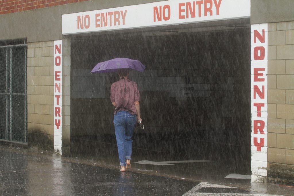 The sleeting rain was not enough to stop this Maryborough woman from heading to Woolworths to shop. Photo: Robyne Cuerel / Fraser Coast Chronicle. Picture: Robyne Cuerel