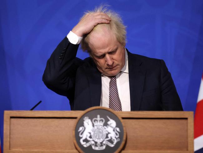 (FILES) In this file photo taken on November 27, 2021 Britain's Prime Minister Boris Johnson gestures as he attends a media briefing on the latest Covid-19 update in the Downing Street briefing room, central London. - Britain's former prime minister Boris Johnson said Tuesday he inadvertently misled parliament over the "Partygate" scandal but blamed top aides, ahead of a televised grilling that could determine his political fate. Johnson released a 52-page dossier detailing why he denied breaking the rules over two years of Covid lockdowns, when his staff were often partying in 10 Downing Street. (Photo by Hollie Adams / POOL / AFP)